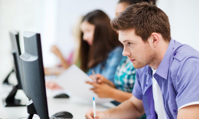 education concept - student with computer studying at school